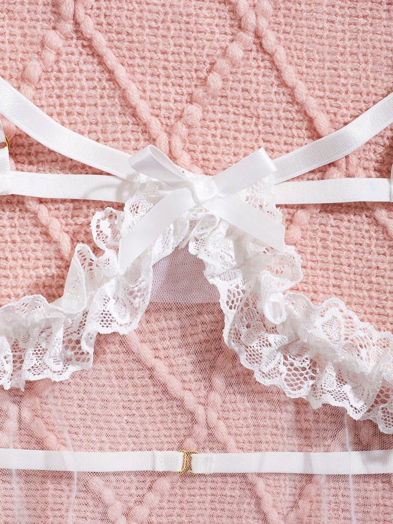 Women's baby pink babydoll nightgown with sheer backless design, bow detail, plunge neckline, adjustable straps, and short slip silhouette.