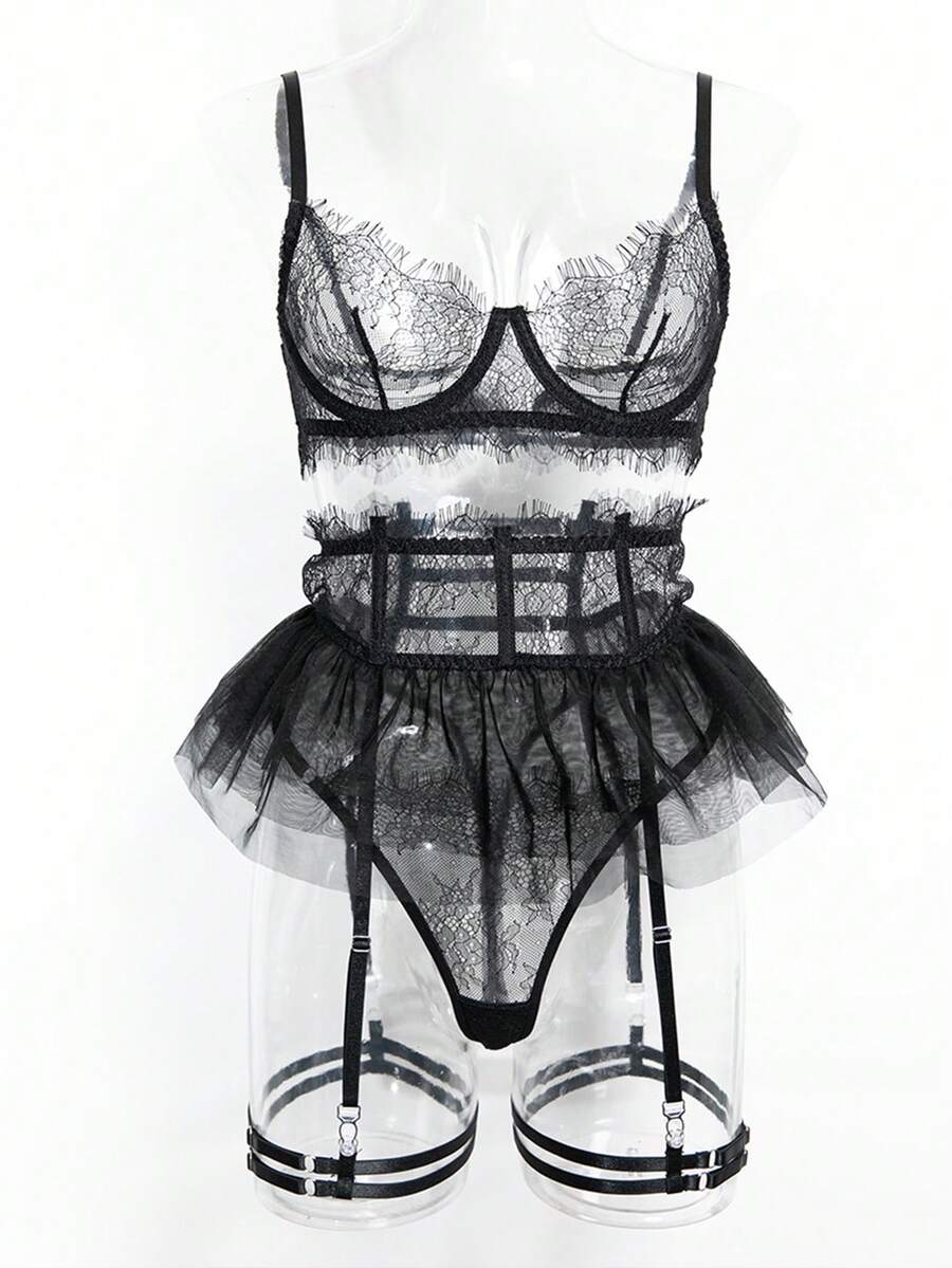 Front view of a 5-piece black lace lingerie set featuring an underwire bra with contrast mesh, matching garter belt, ruffle skirt, and high-rise thong.