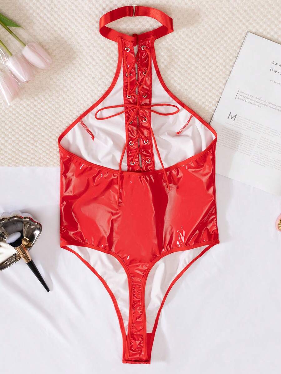 Women's black PU leather halter neck bodysuit lingerie with cut-out front, lace-up detail, and backless crossback straps.