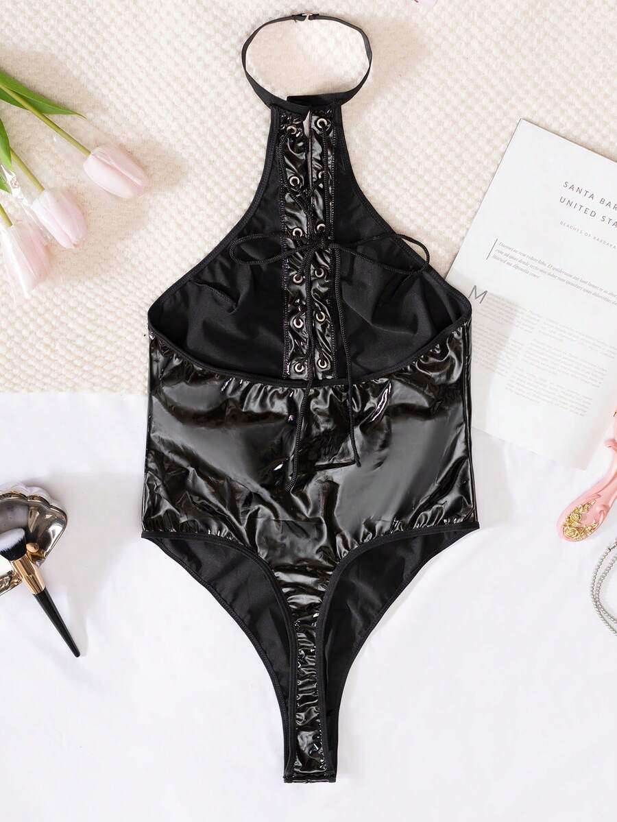 Women's black PU leather halter neck bodysuit lingerie with cut-out front, lace-up detail, and backless crossback straps.