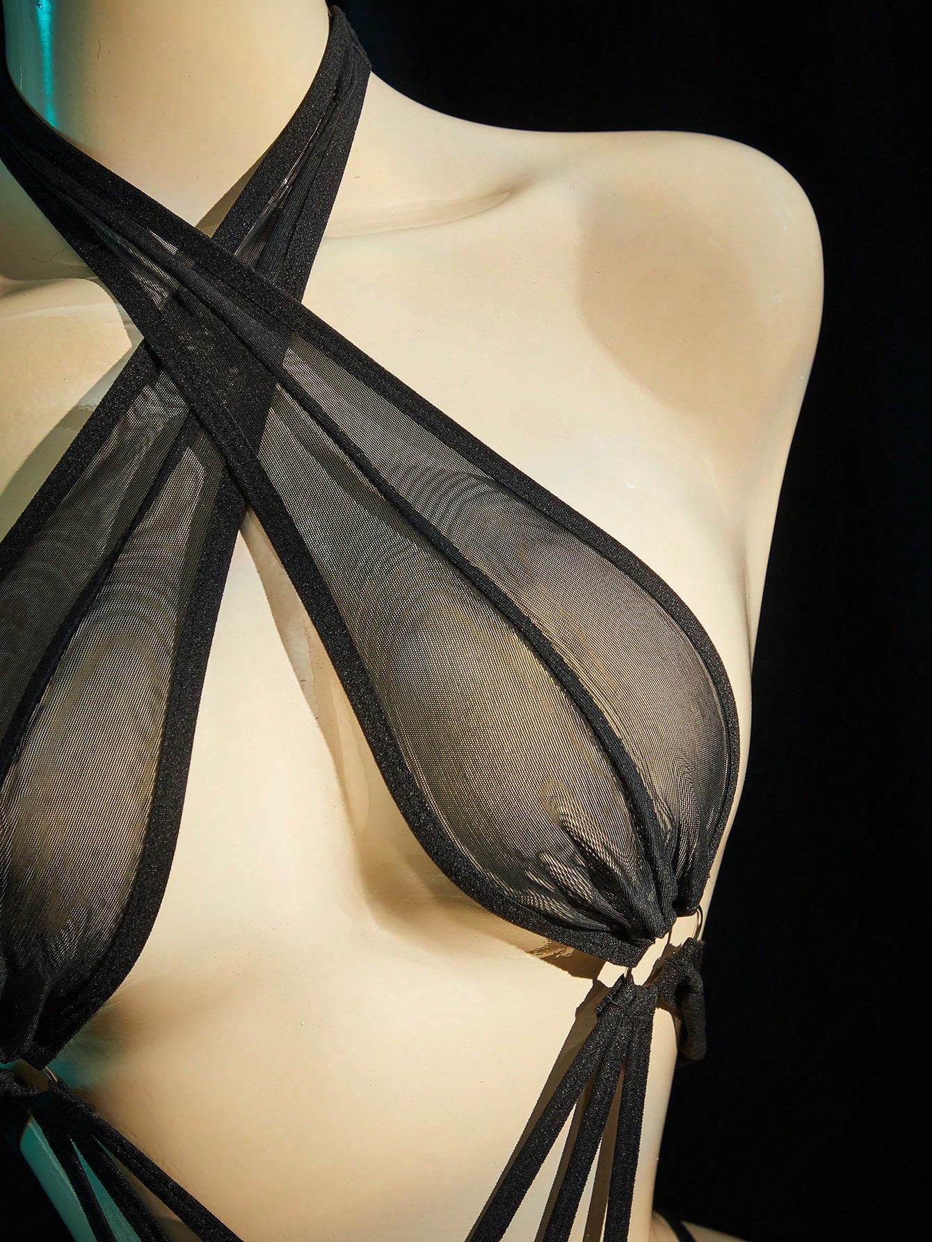 Women's black sheer mesh bodysuit with halter neckline, backless design, wireless fit, and plain finish.
