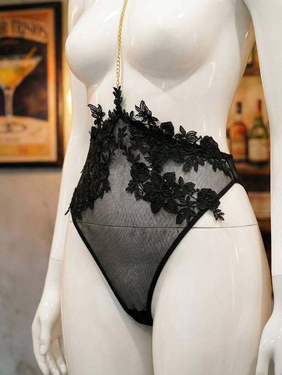 Black sheer halter backless lingerie bodysuit and matching bunny ear headwear for plus size women, featuring adjustable straps and tie-back detailing.