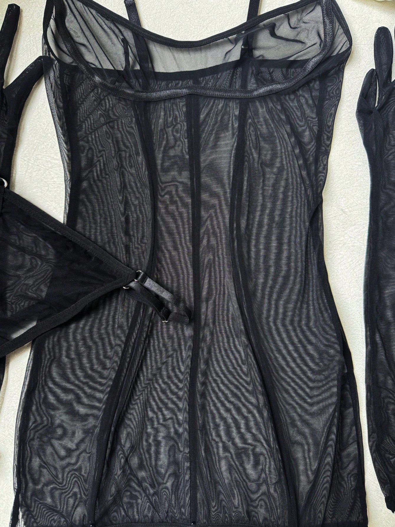 Women's black sheer mesh lingerie set with adjustable spaghetti straps, wireless design, V-string panty, garter belt, and matching gloves