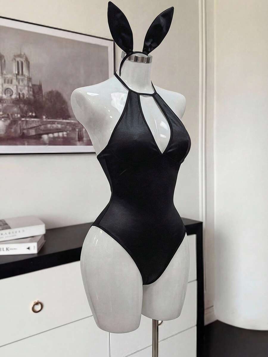 Front view of a black satin halter neck lingerie bodysuit featuring wireless support, sheer details, and adjustable straps.