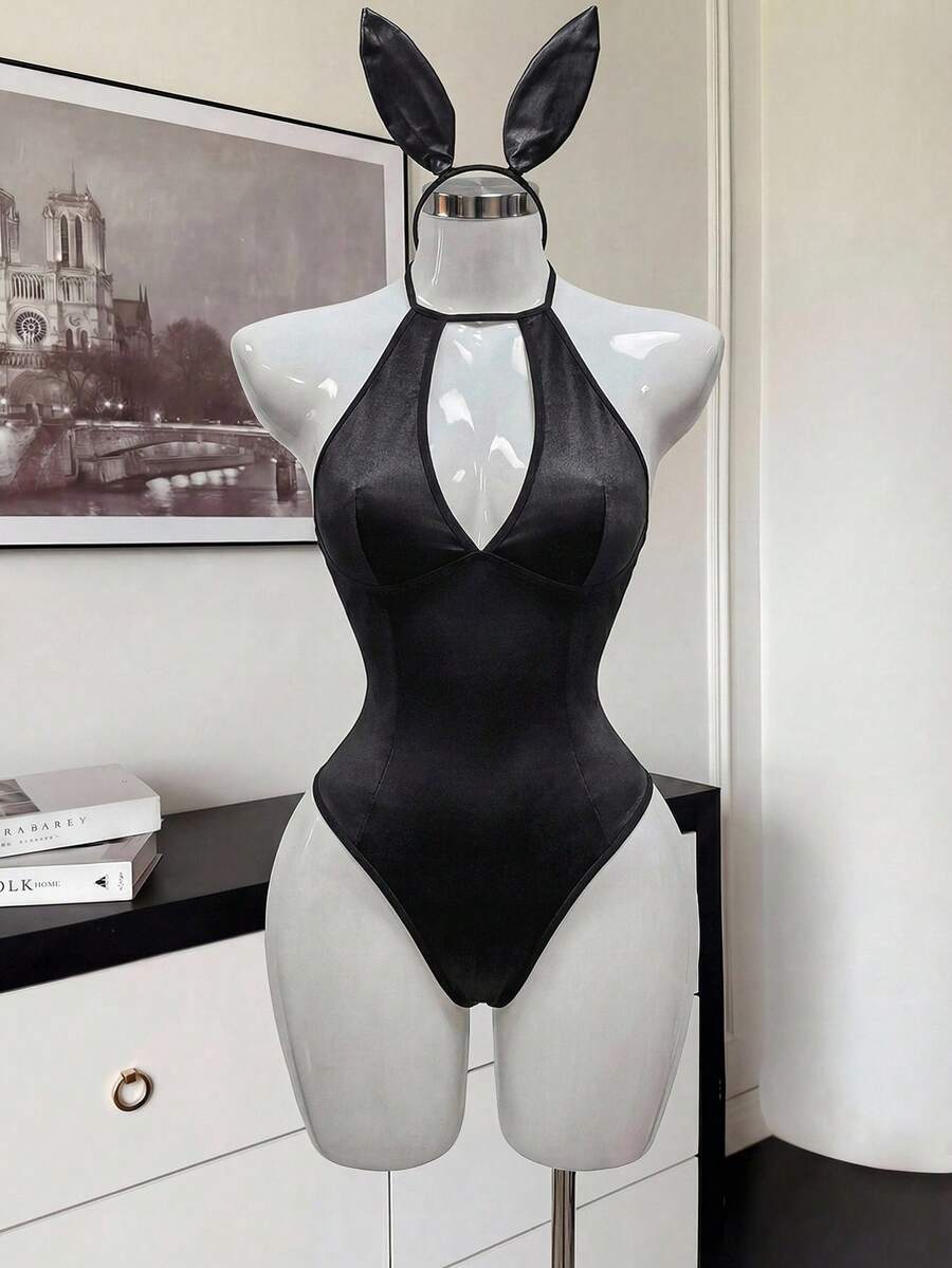 Front view of a black satin halter neck lingerie bodysuit featuring wireless support, sheer details, and adjustable straps.