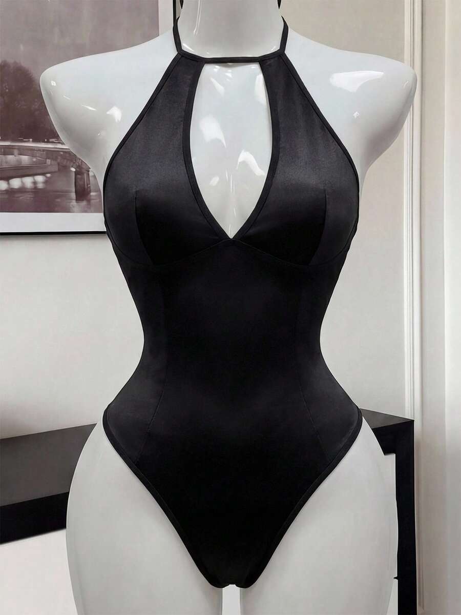 Front view of a black satin halter neck lingerie bodysuit featuring wireless support, sheer details, and adjustable straps.
