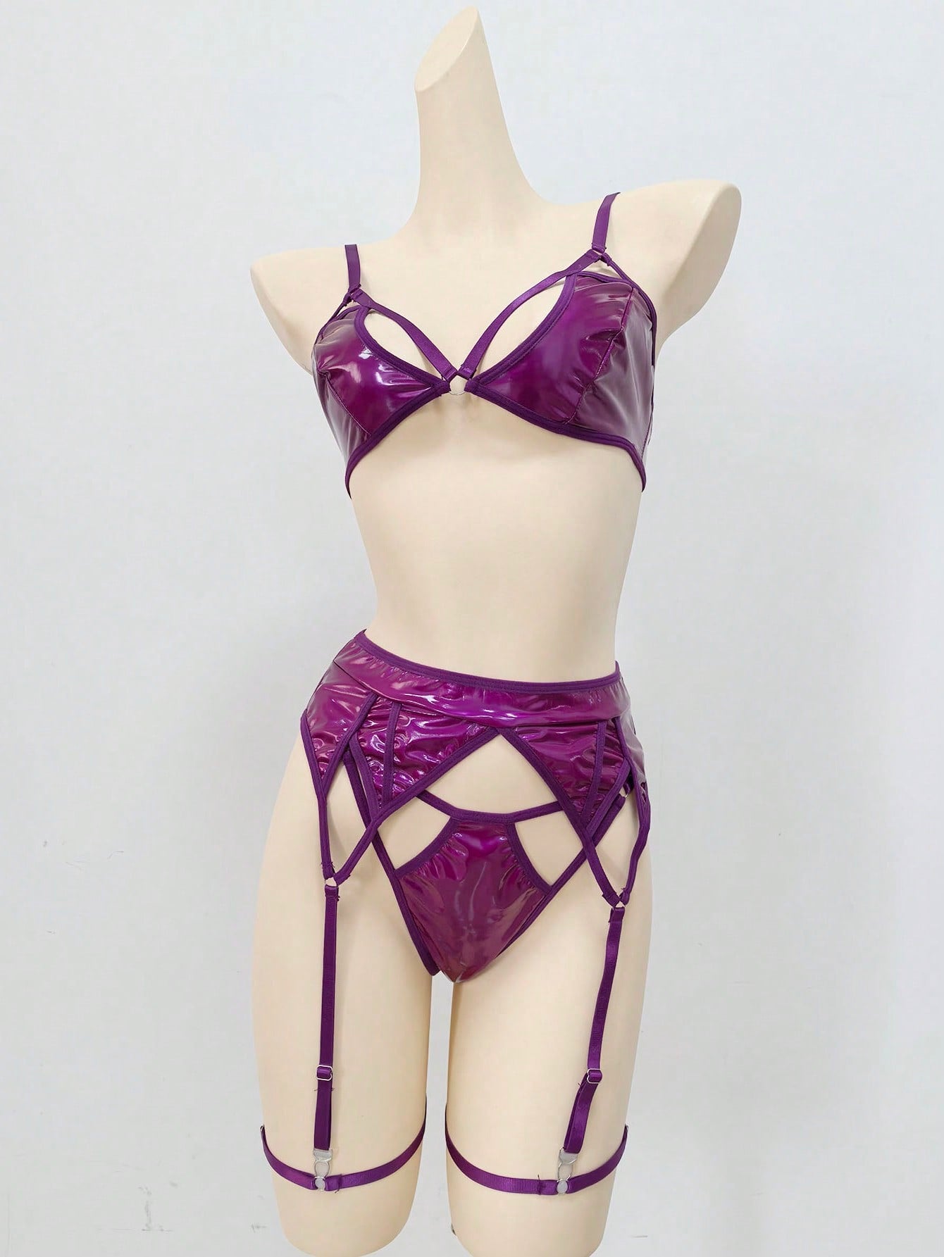 Women's 4-piece wireless lingerie set with cut-out bralette, adjustable spaghetti straps, V-string panty, and matching body accessories in plain style.