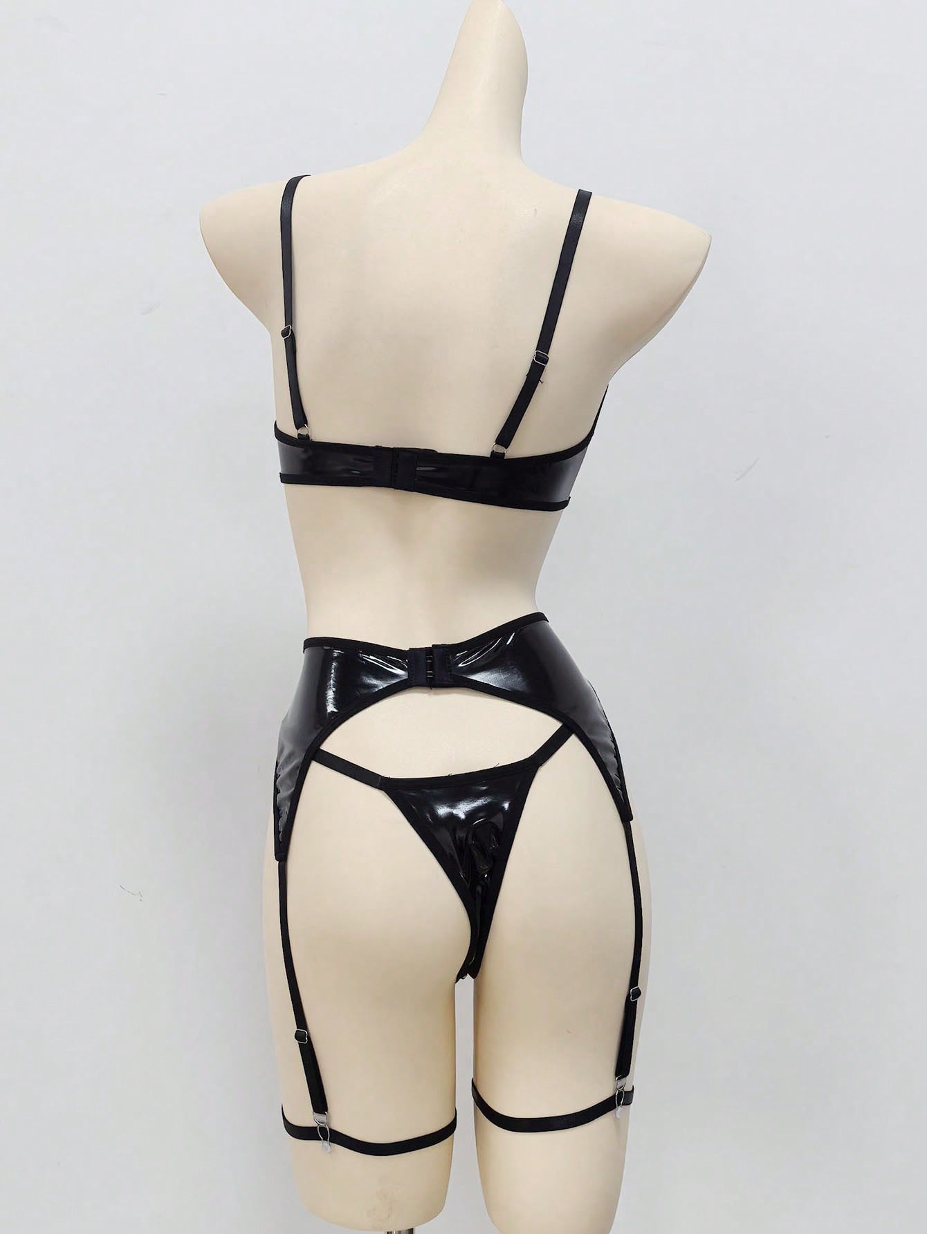 Women's 4-piece wireless lingerie set with cut-out bralette, adjustable spaghetti straps, V-string panty, and matching body accessories in plain style.