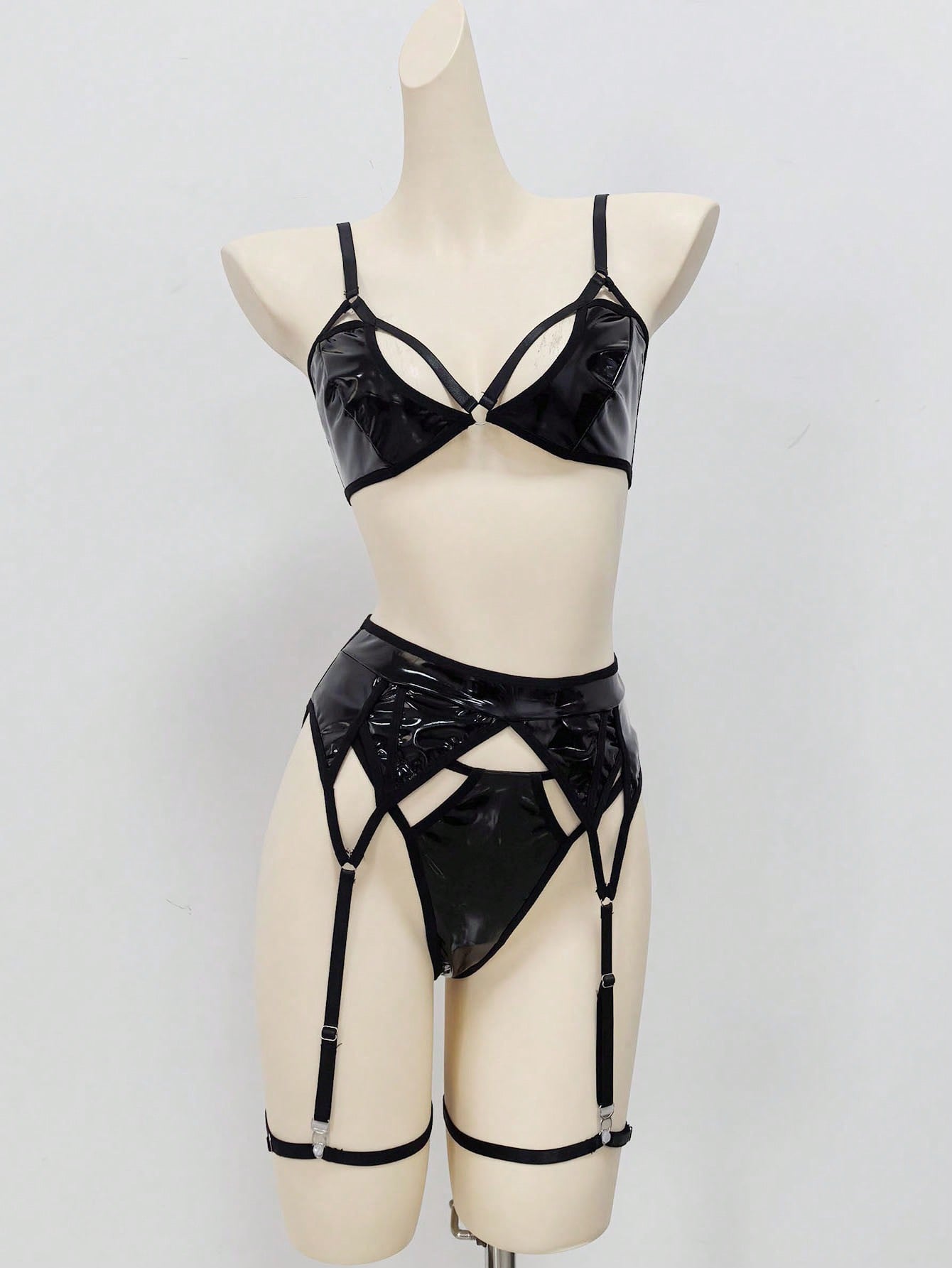 Women's 4-piece wireless lingerie set with cut-out bralette, adjustable spaghetti straps, V-string panty, and matching body accessories in plain style.