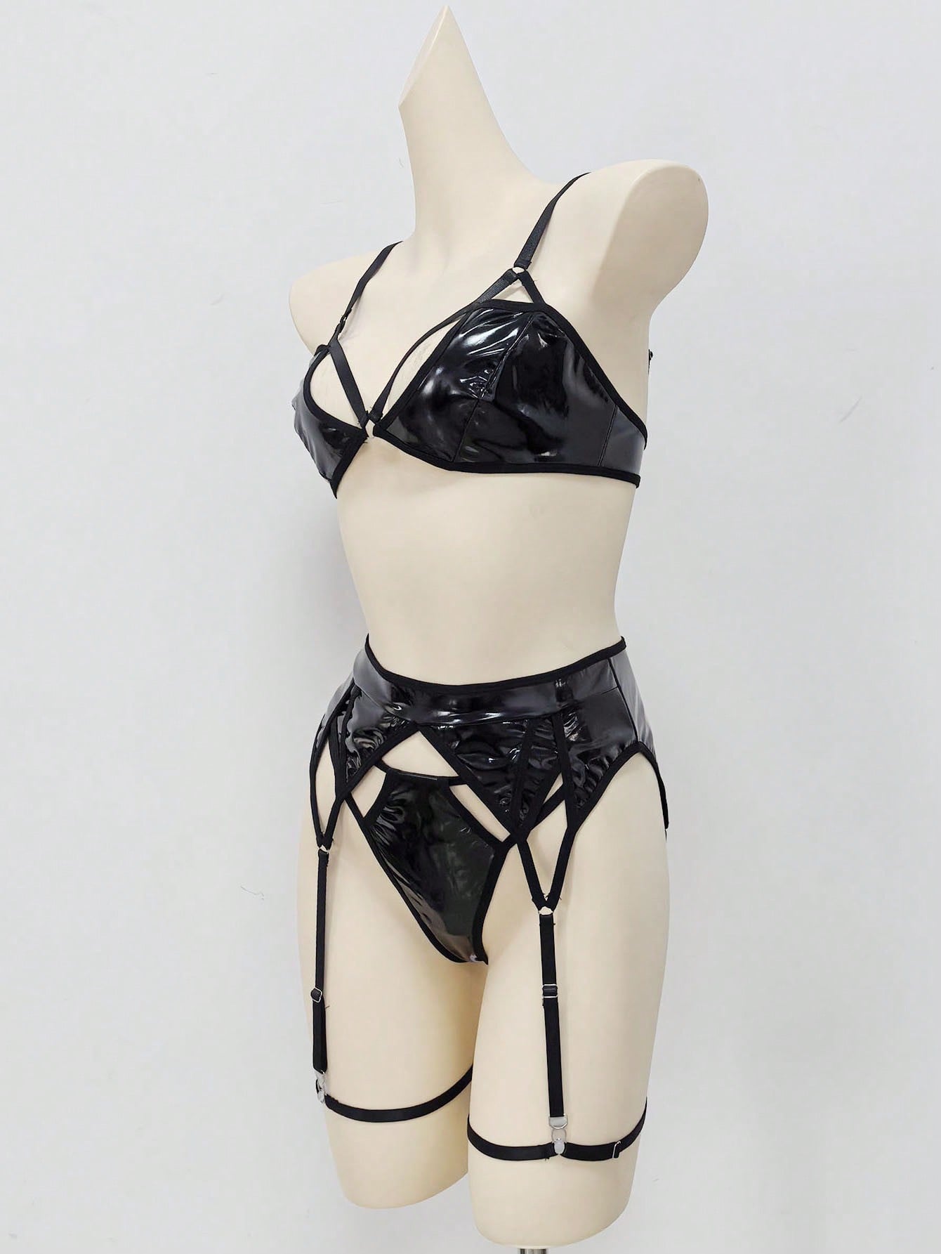 Women's 4-piece wireless lingerie set with cut-out bralette, adjustable spaghetti straps, V-string panty, and matching body accessories in plain style.