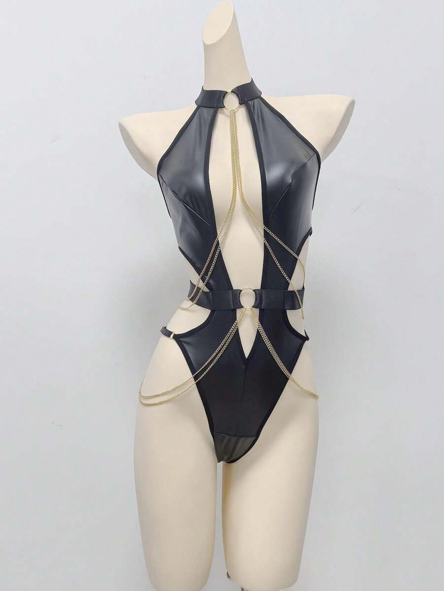 Front view of a women's black PU leather halter teddy bodysuit with cut-out details, metallic chain accents, and ring hardware.