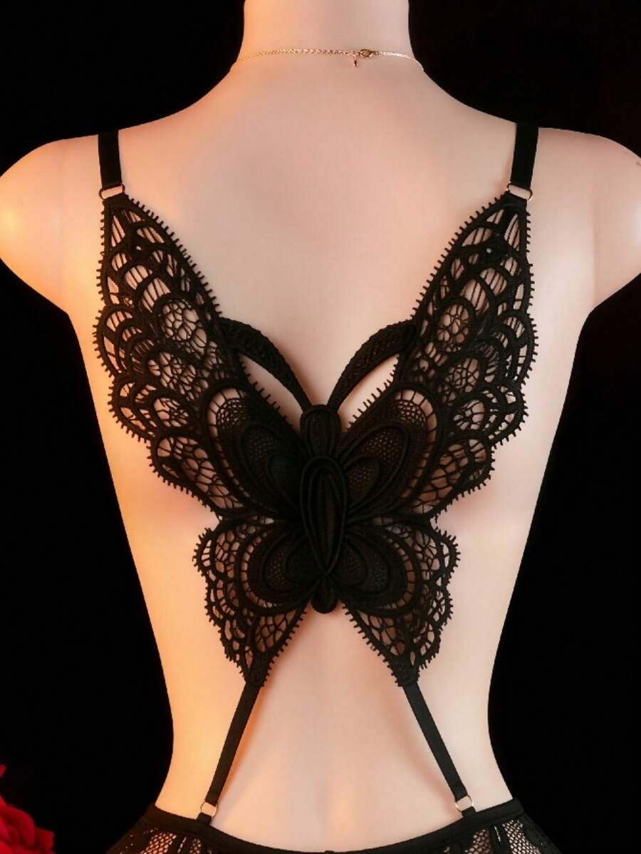 Women's black lace jumpsuit lingerie featuring adjustable spaghetti straps, low cut neckline with bow detail, and sheer medium stretch fabric.