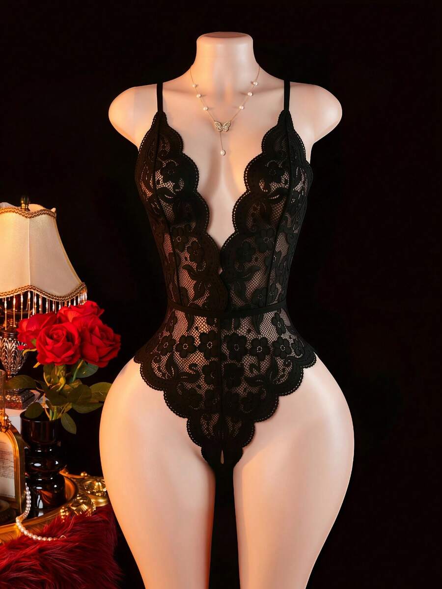 Women's black lace jumpsuit lingerie featuring adjustable spaghetti straps, low cut neckline with bow detail, and sheer medium stretch fabric.