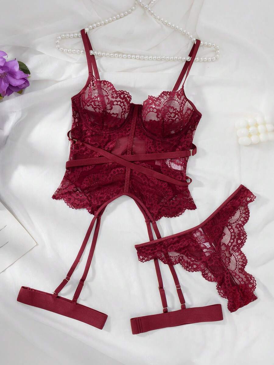 3-piece black lace lingerie set featuring a longline underwire 1/2 cup bra with adjustable spaghetti straps, cut out details, and matching low-rise thong