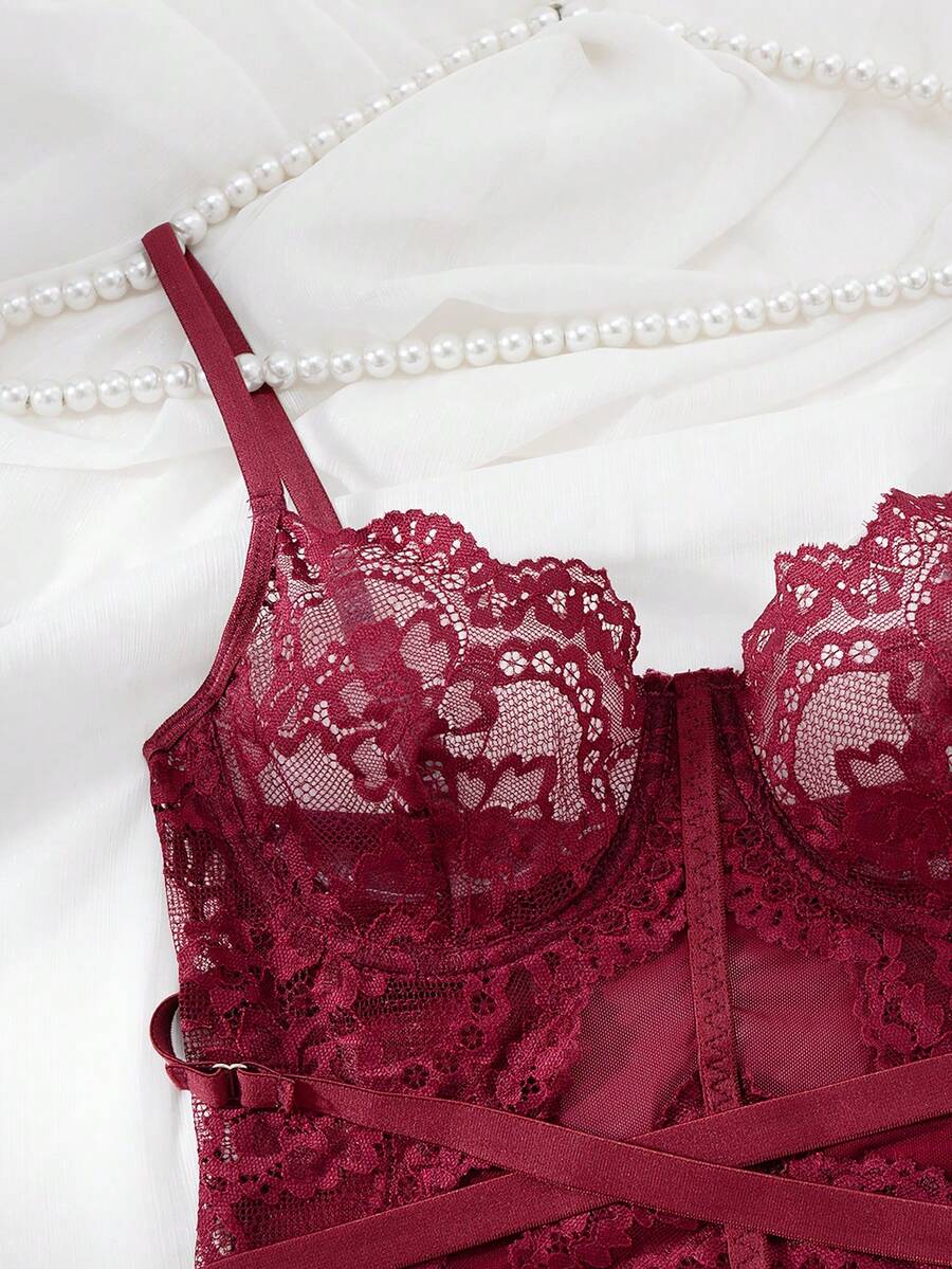 3-piece black lace lingerie set featuring a longline underwire 1/2 cup bra with adjustable spaghetti straps, cut out details, and matching low-rise thong