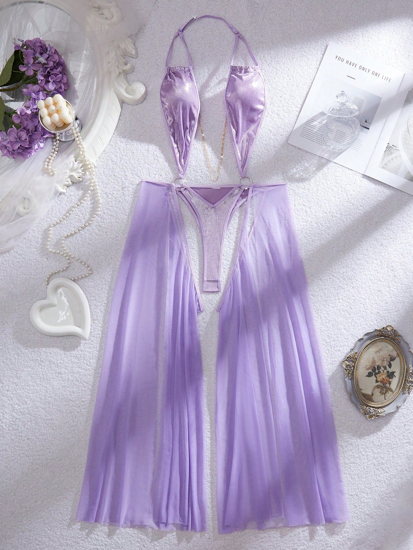 Women's halter lingerie slip dress in semi-sheer mesh with adjustable straps, backless cut-out design, chain detail, and wireless teddy-style fit.