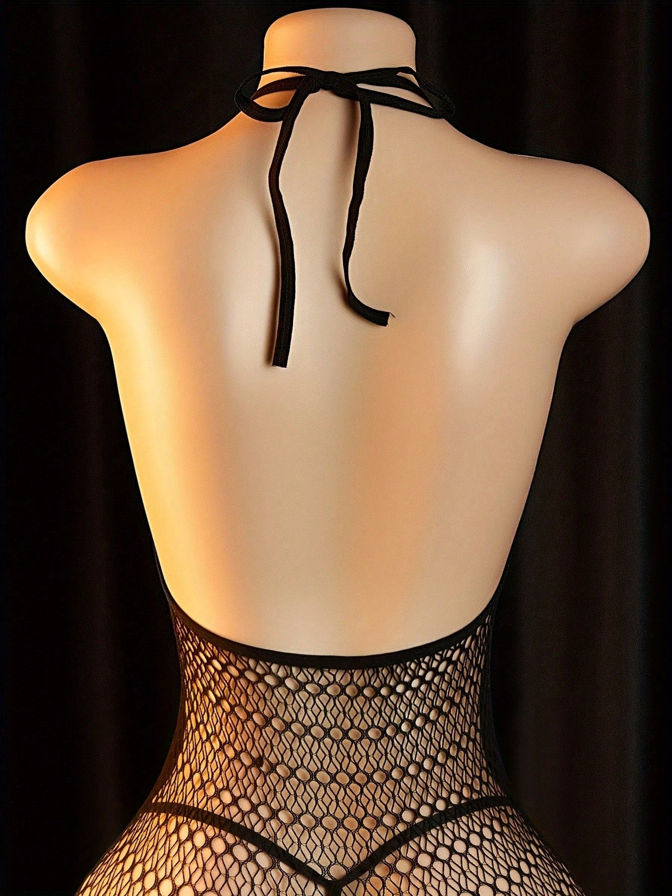 Women's fishnet lingerie set with lace-up detail, contrast lace, spaghetti straps, triangle bra styling, thong bottom, and semi-sheer stretch polyamide fabric.