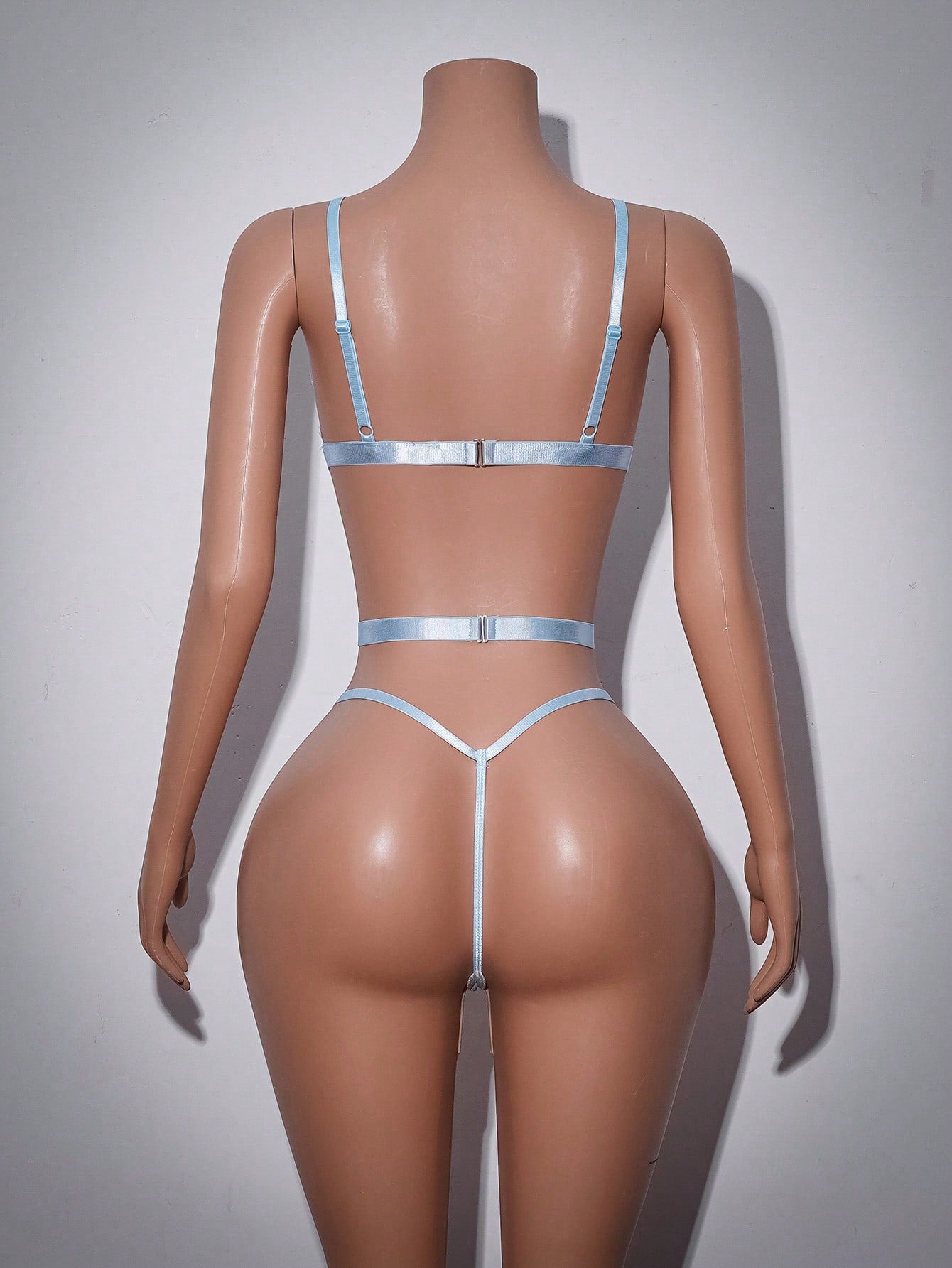 Women’s baby blue lace teddy bodysuit with sheer cut-out design, adjustable straps, V-neck, underwire triangle cups, and thong back.
