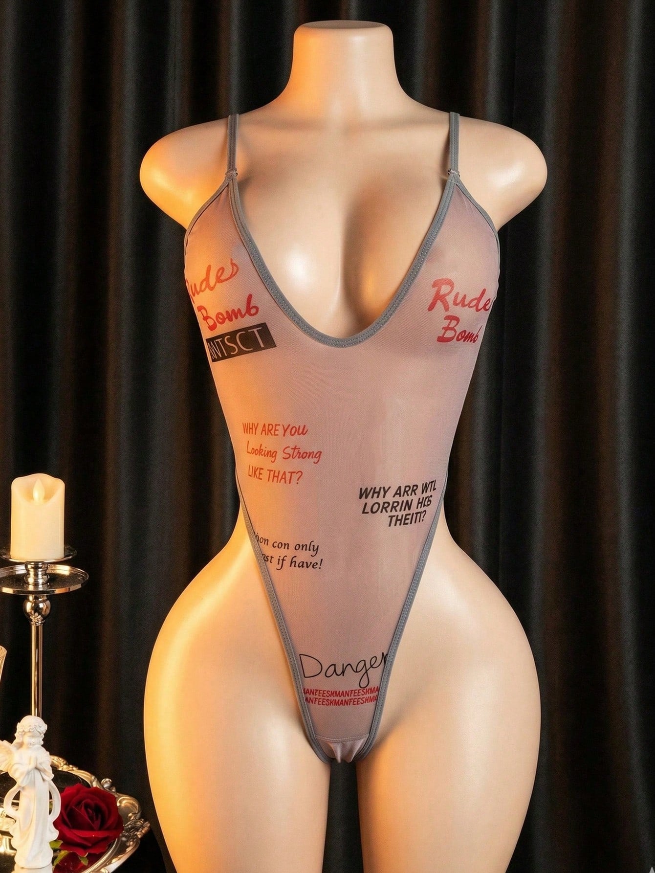 Women's sheer mesh lingerie jumpsuit in grey with a deep V neckline, adjustable straps, thong cut, and high-stretch one-piece design.