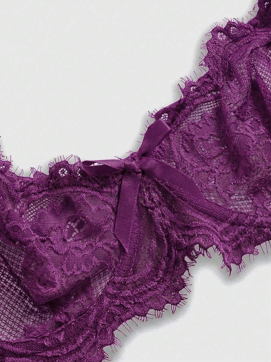 Black sheer floral lace plunge bra featuring underwire support, unlined triangle cups, adjustable straps, and a backless design for women.