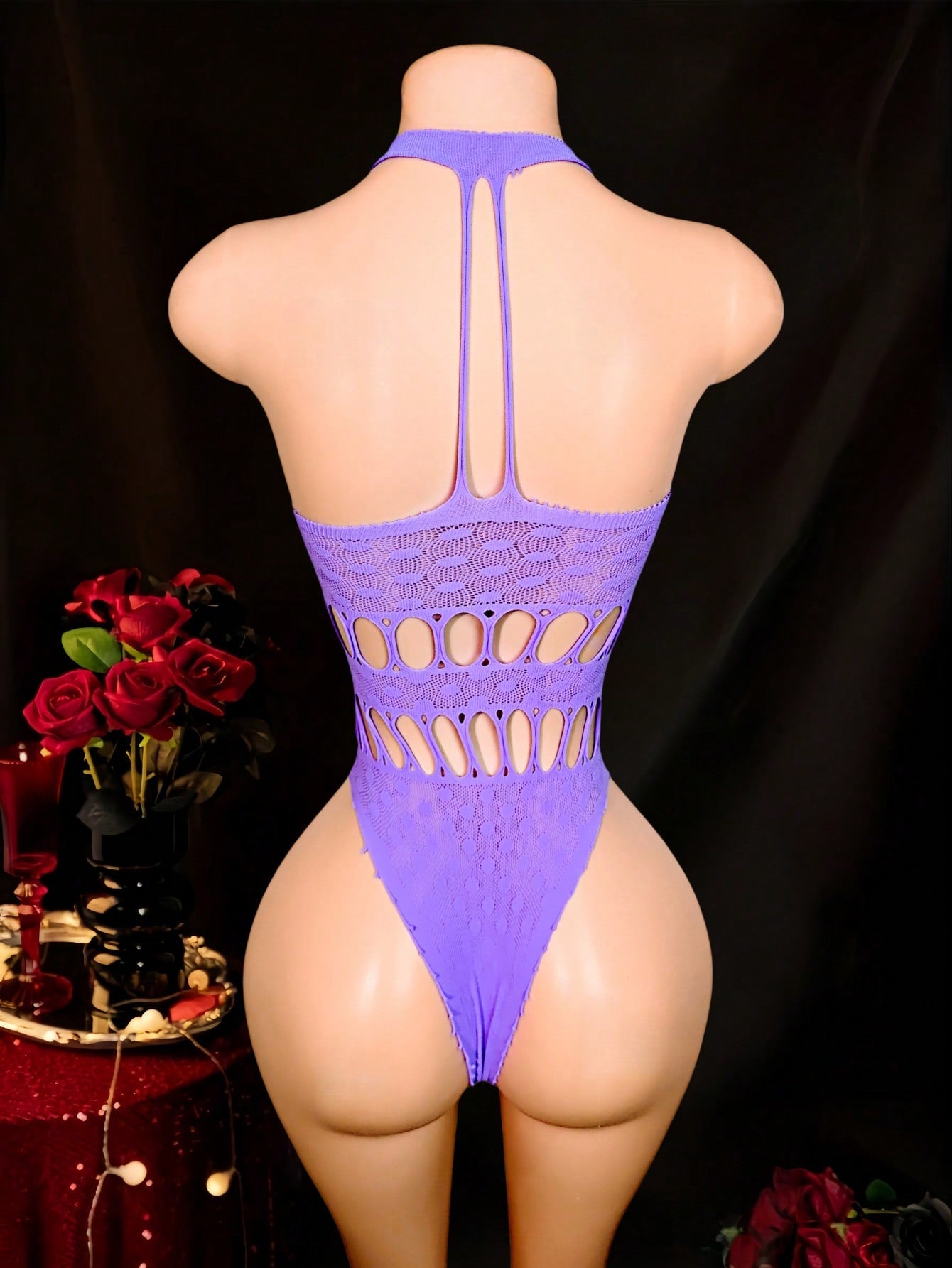 Women's fishnet sheer bodysuit with spaghetti straps, boat neckline, cut-out detail, sleeveless design, and high-stretch knitted fabric.