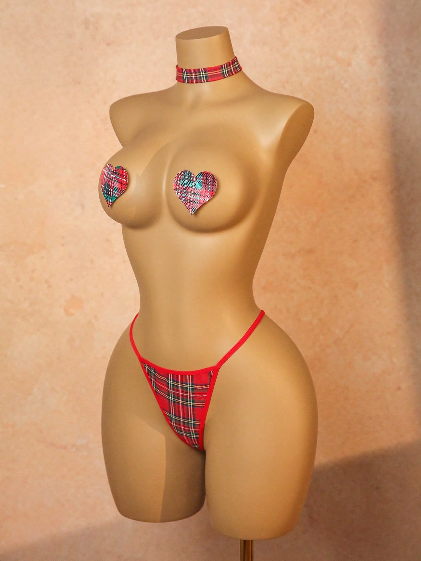 Women's red plaid 3-piece lingerie cosplay set with chest stickers, low-rise thong panties, and matching choker in polyester blend with adjustable straps and halter neckline.