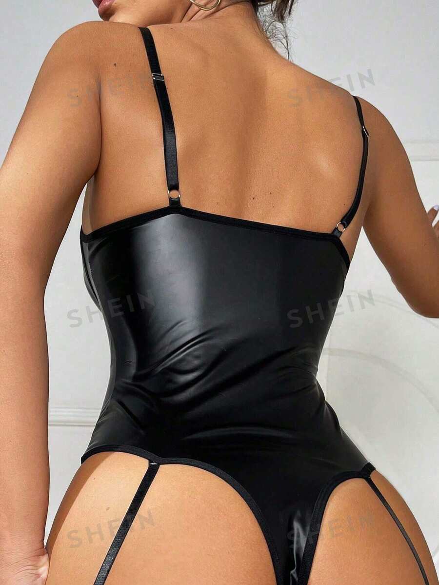 Women's black lingerie bodysuit featuring contrast mesh, lace-up front, cut-out detailing, adjustable spaghetti straps, and low rise thong panty.