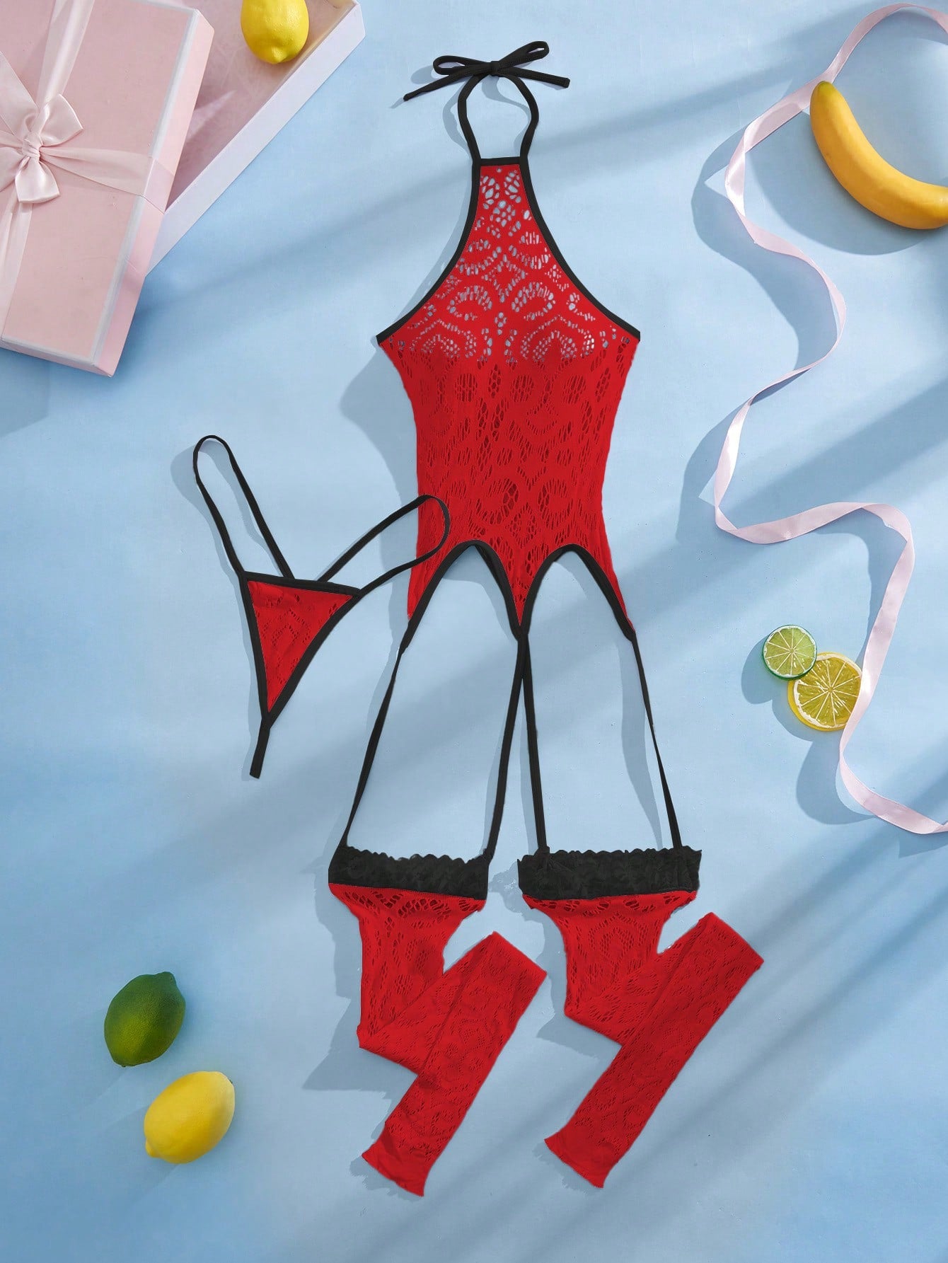 Women's semi-sheer mesh lingerie bodysuit set with halter neckline, backless design, hollow out details, bow accent, and thong styling in pink colorblock fabric.