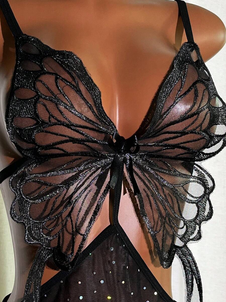 Women's black semi-sheer glitter mesh babydoll lingerie featuring embroidered accents, lace-up front detail, and a wireless bralette design.