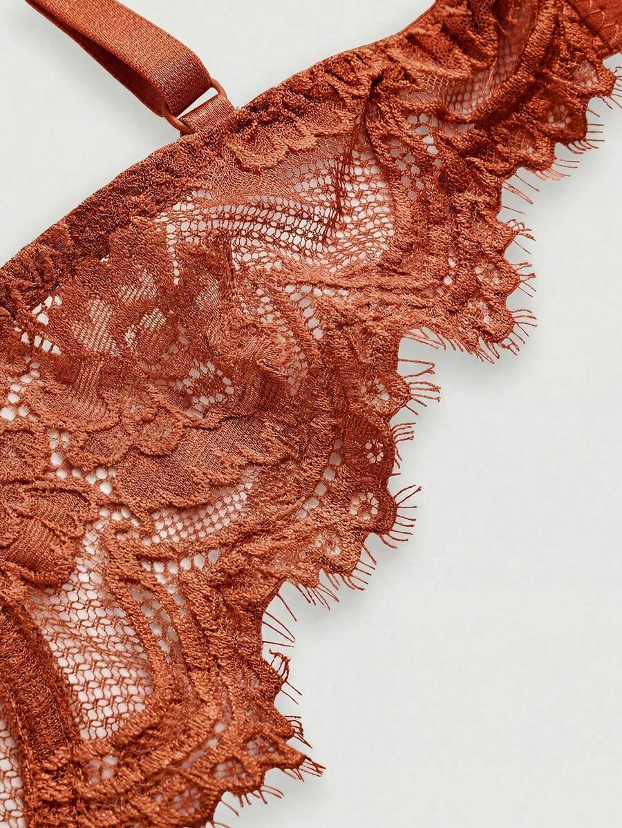 Black sheer floral lace plunge bra featuring underwire support, unlined triangle cups, adjustable straps, and a backless design for women.
