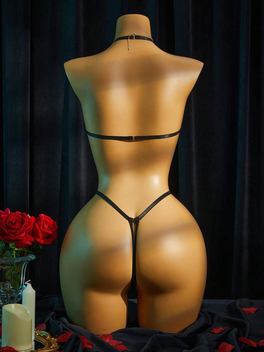 Women's halter neck faux leather bodysuit lingerie featuring a backless design, knot details, and adjustable straps.