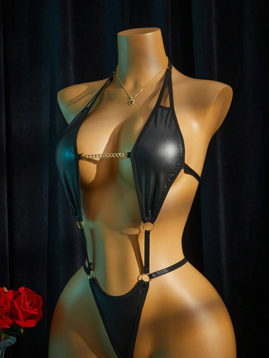 Women's halter neck faux leather bodysuit lingerie featuring a backless design, knot details, and adjustable straps.