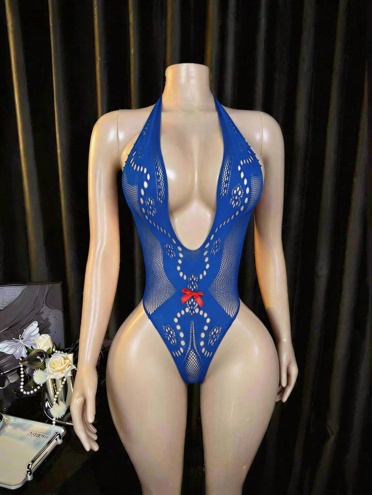 Women's fishnet lingerie bodysuit featuring long sleeves, a halter neckline, hollow out details, and sheer high stretch fabric.