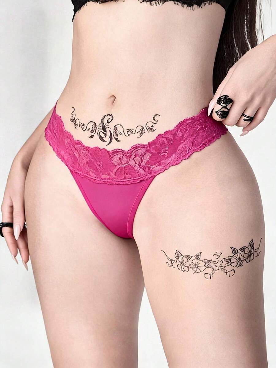 Gothic lace thong panties in black featuring low rise waistband with cross strap and bow detail