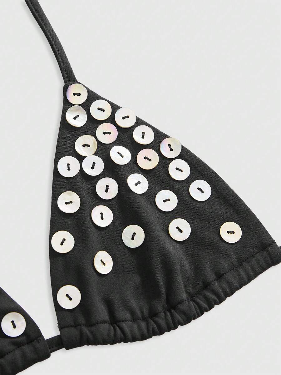 Women's black knitted halter micro crop top featuring studded details, high stretch fabric, and an asymmetrical hem.