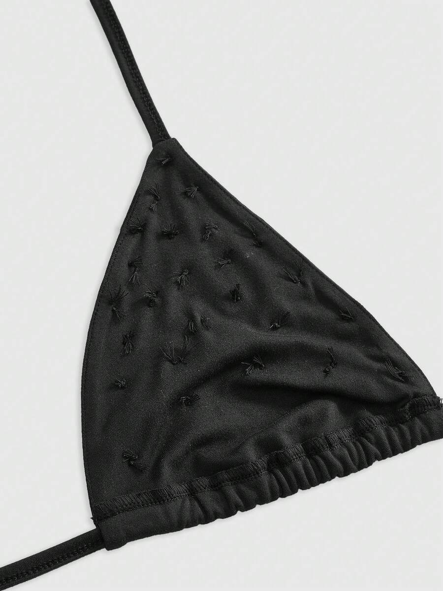Women's black knitted halter micro crop top featuring studded details, high stretch fabric, and an asymmetrical hem.