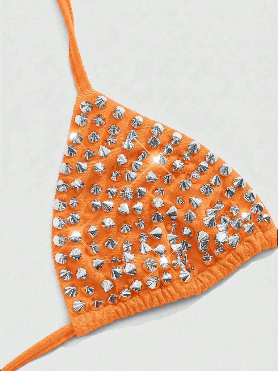Women's black knitted halter micro crop top featuring studded details, high stretch fabric, and an asymmetrical hem.