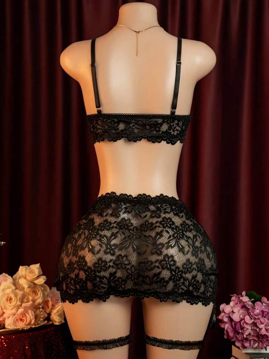 Black 4-piece women's lace bodycon dress lingerie set featuring heart rhinestone spaghetti straps, wireless bralette, thong, and ruffle hem garter.