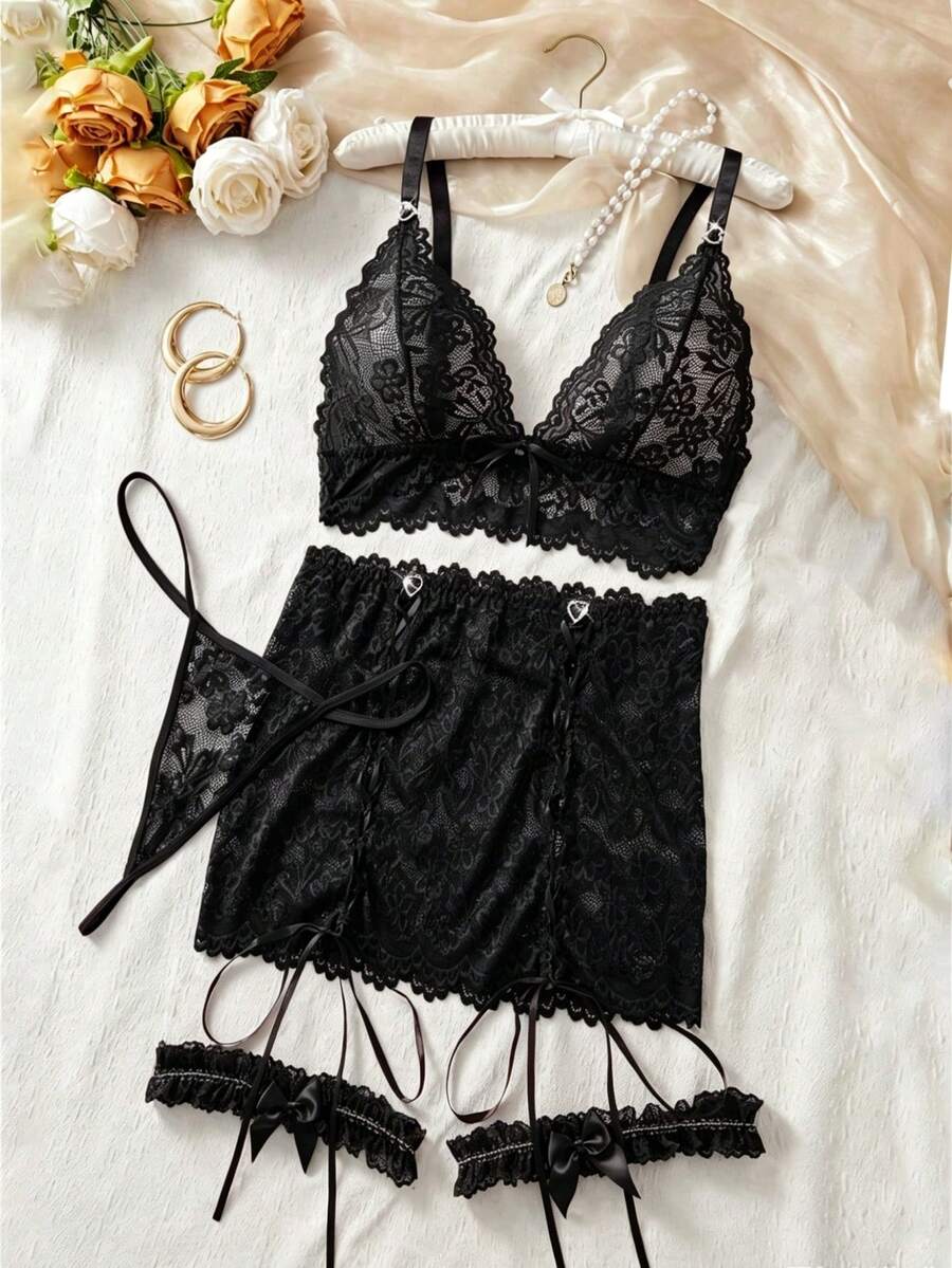 Black 4-piece women's lace bodycon dress lingerie set featuring heart rhinestone spaghetti straps, wireless bralette, thong, and ruffle hem garter.