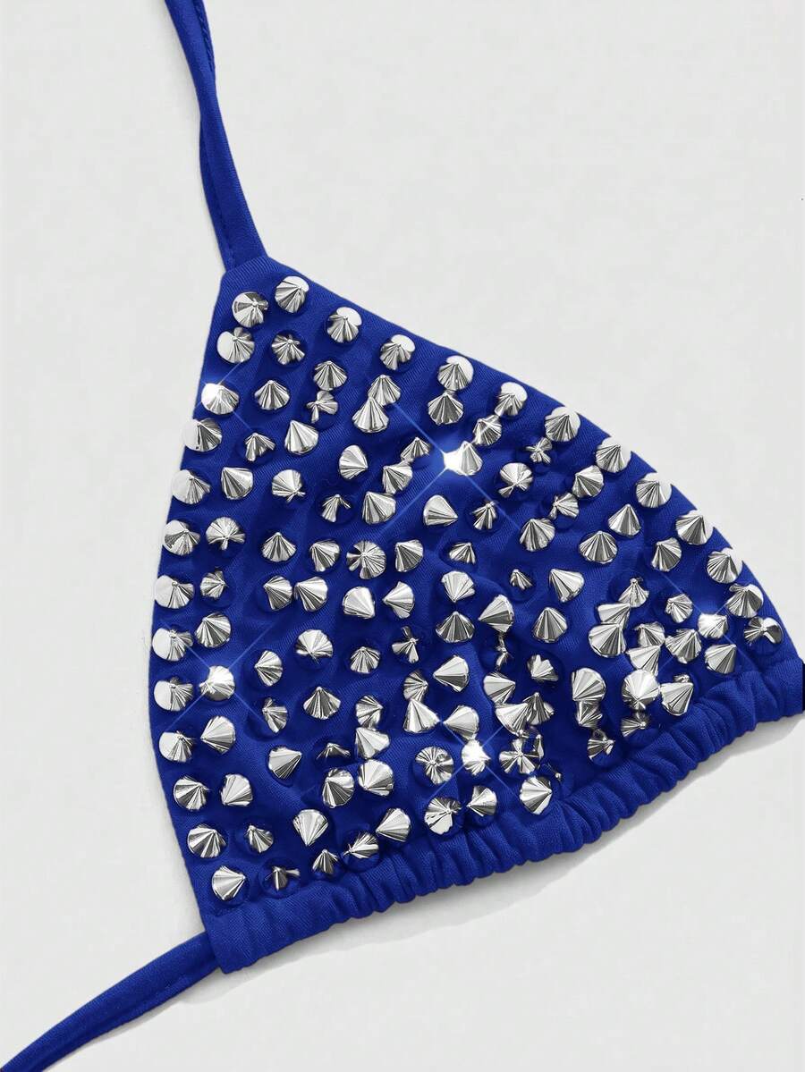 Women's black knitted halter micro crop top featuring studded details, high stretch fabric, and an asymmetrical hem.