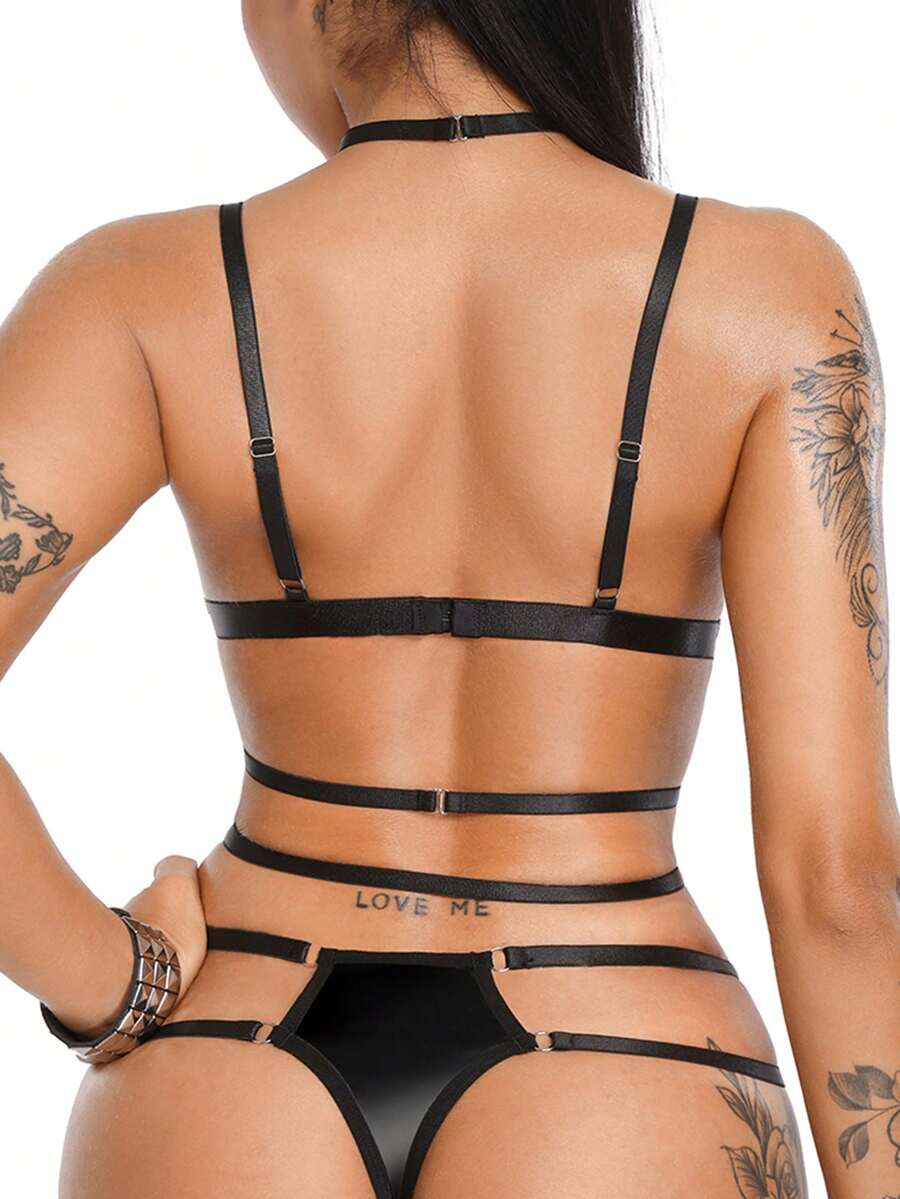 Black 3-piece women's goth lingerie set featuring a rivet lace-up wireless camisole bra, backless design, adjustable straps, and matching mid-rise briefs.