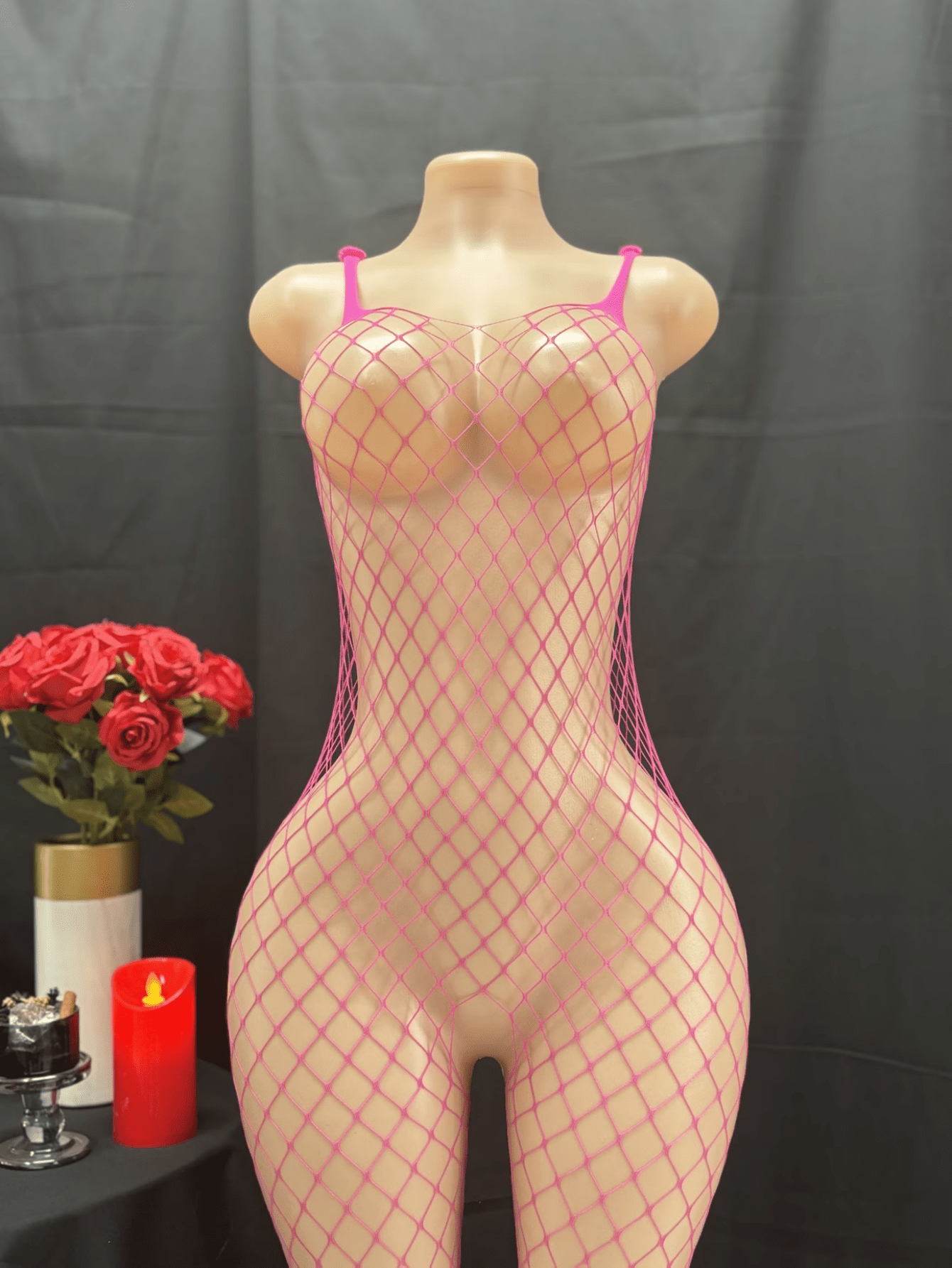 Black sheer fishnet crotchless body stocking for women with hollow cut-out design and high stretch knitted fabric.