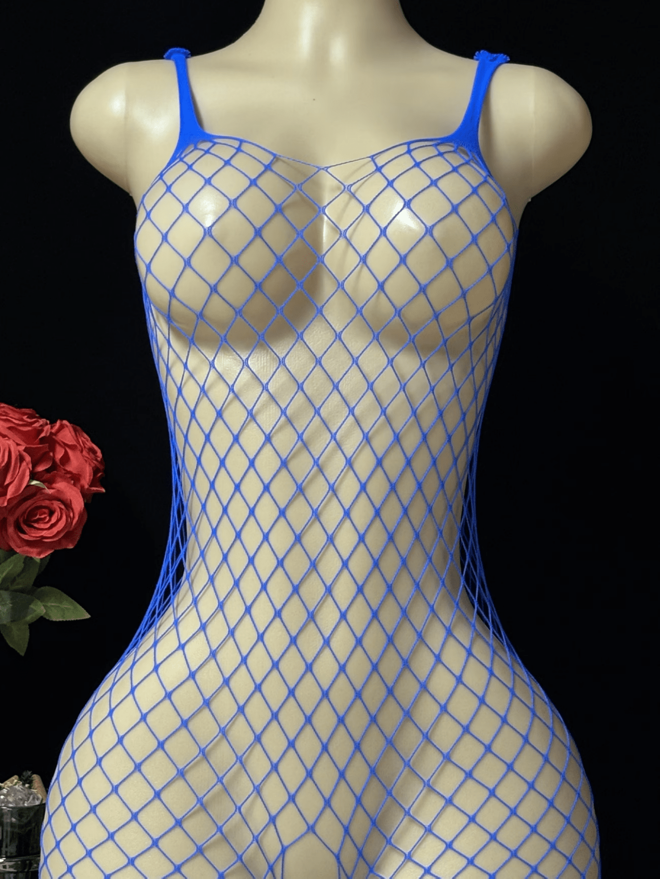 Black sheer fishnet crotchless body stocking for women with hollow cut-out design and high stretch knitted fabric.