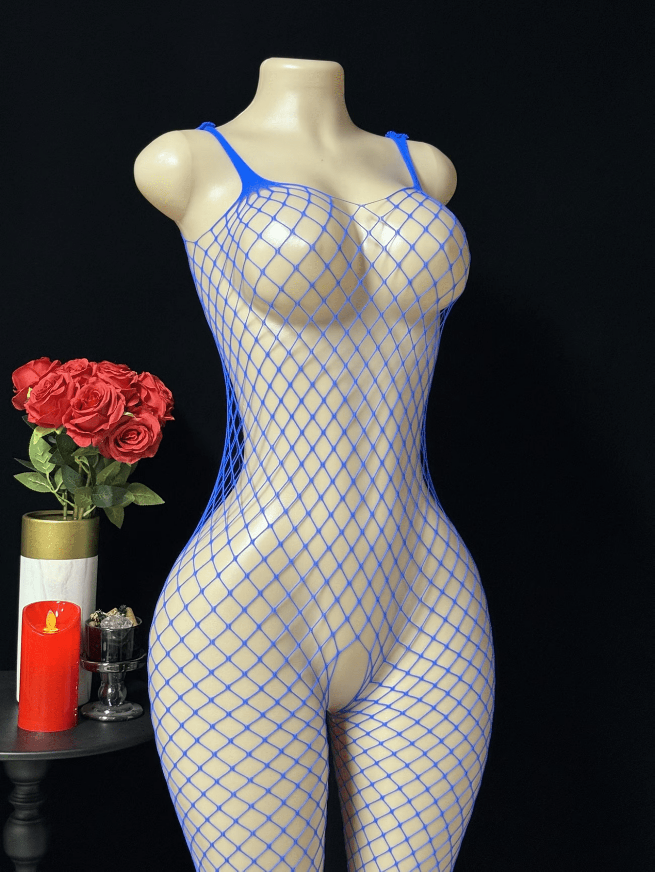 Black sheer fishnet crotchless body stocking for women with hollow cut-out design and high stretch knitted fabric.