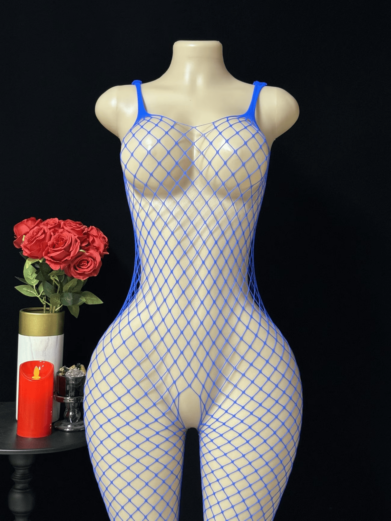 Black sheer fishnet crotchless body stocking for women with hollow cut-out design and high stretch knitted fabric.