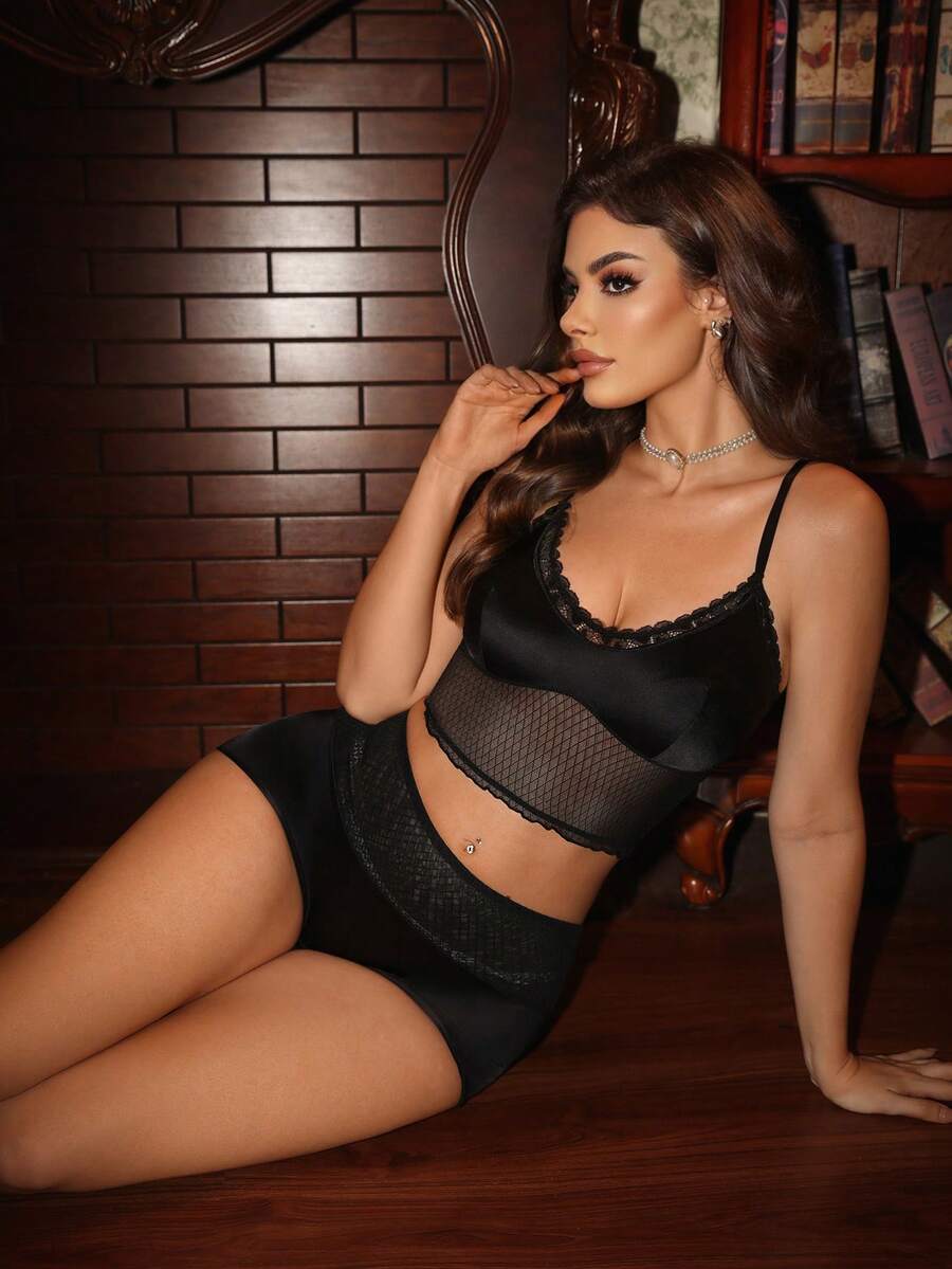 Women's 2-piece black lace mesh lingerie set featuring a backless cami top with contrast lace trim, adjustable straps, and matching low-rise boyshorts.