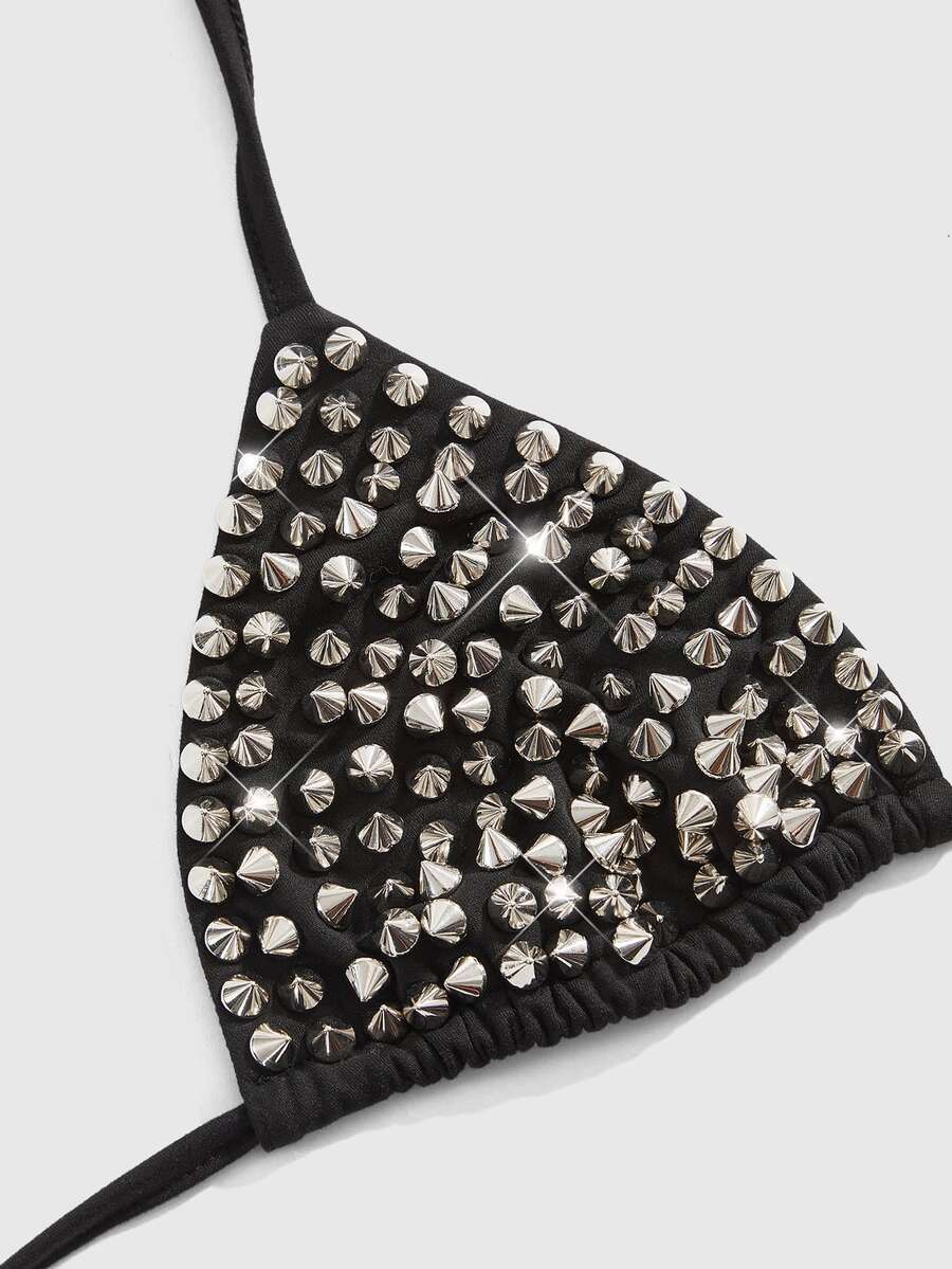 Women's black knitted halter micro crop top featuring studded details, high stretch fabric, and an asymmetrical hem.