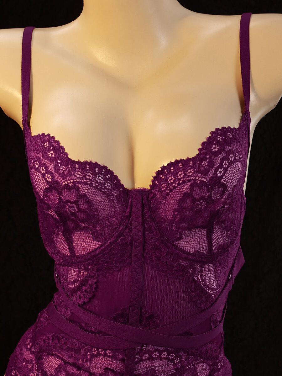 3-piece black lace lingerie set featuring a longline underwire 1/2 cup bra with adjustable spaghetti straps, cut out details, and matching low-rise thong